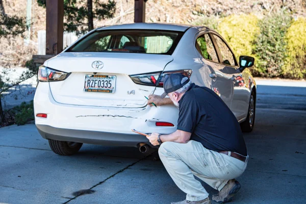 Larry's Body Shop inspecting damage
